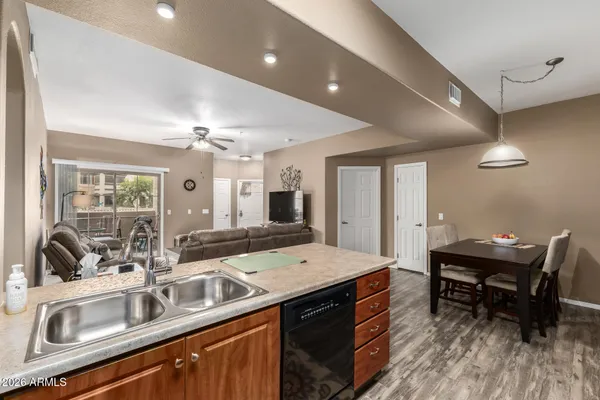 a kitchen with sink and view of living room