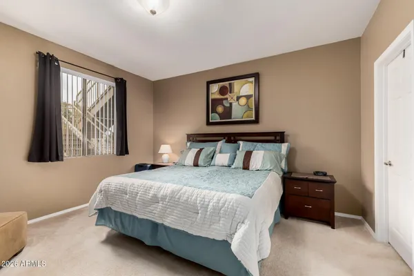 a bedroom with a bed and a window