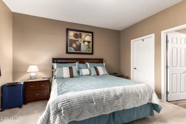 a bedroom with a bed and a lamp