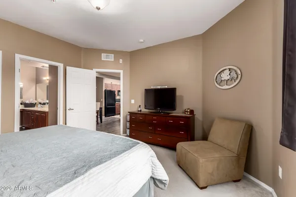 a bedroom with a bed and a television