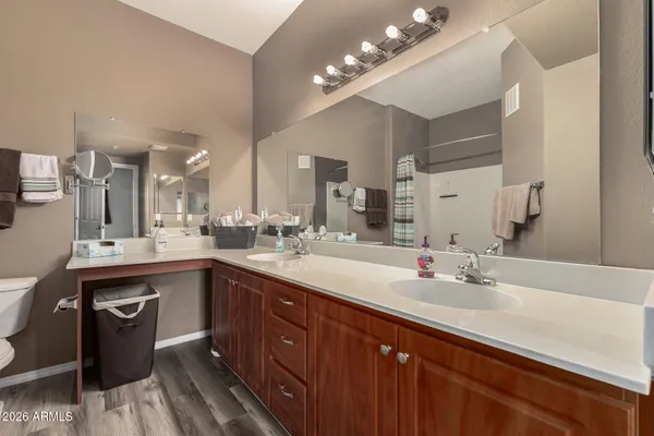a spacious bathroom with a double vanity sink and a mirror
