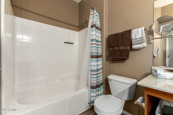 a white toilet sitting next to a bath tub and shower