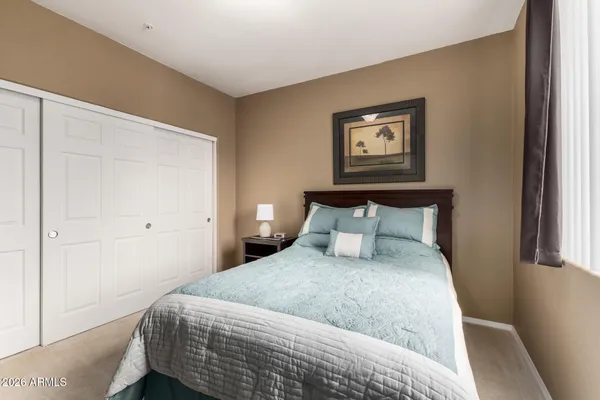 a bedroom with a bed and a window