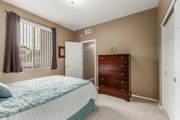 a bedroom with a bed and a dresser