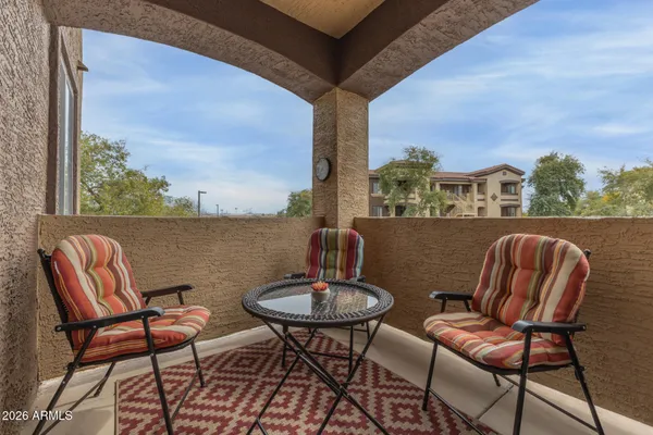 a view of a chairs and table in patio