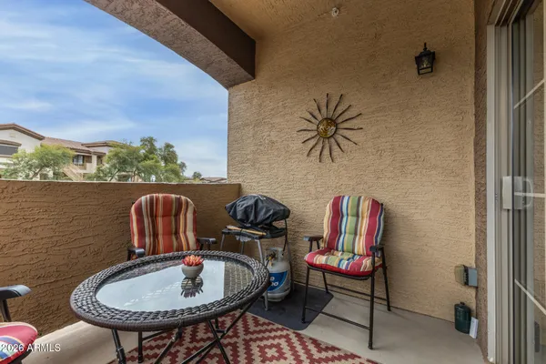 a balcony with table and chairs
