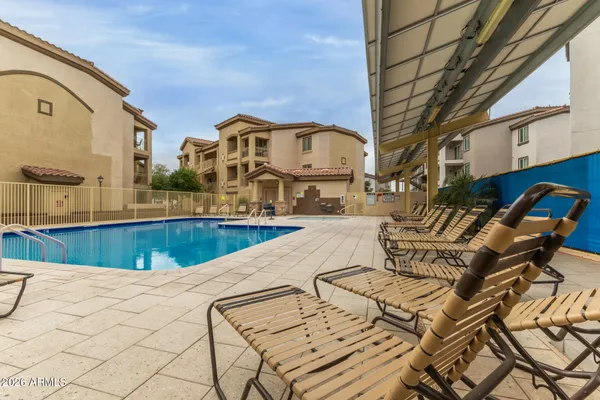 a view of a swimming pool with outdoor seating