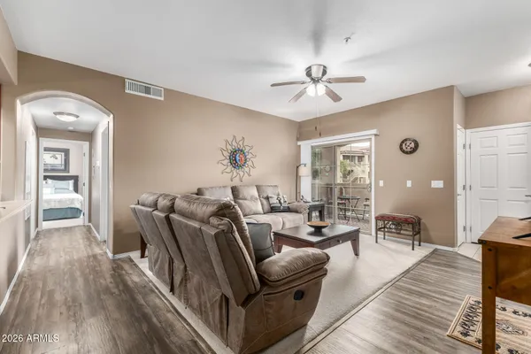 a living room with furniture and wooden floor