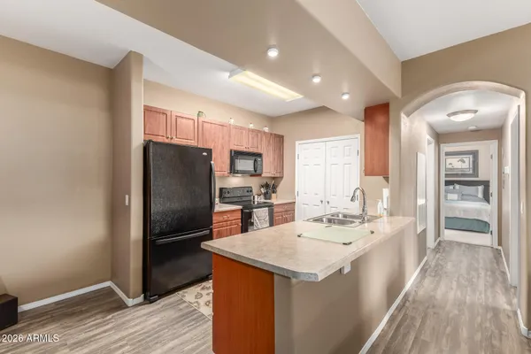 a kitchen with refrigerator cabinets and wooden floor
