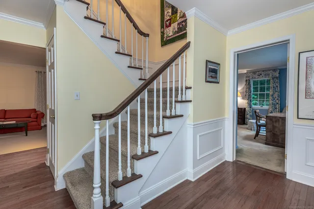 a view of entryway and hall with wooden floor