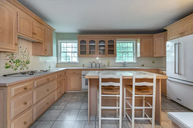 a kitchen with cabinets appliances and a window