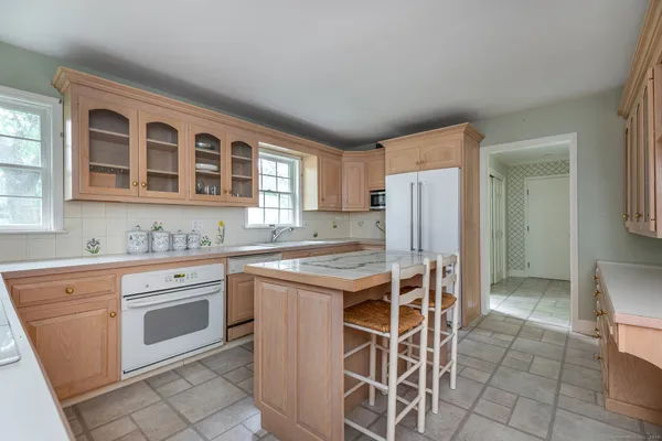 a kitchen with a stove a sink and a refrigerator