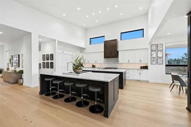 a spacious bathroom with a double vanity sink a mirror and a bathtub