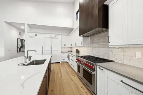 a kitchen with stainless steel appliances granite countertop a sink stove and cabinets