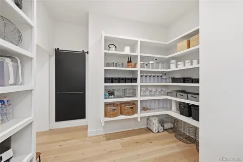 a room with walk in closet with wooden floor and a window