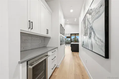 a kitchen with kitchen island a counter top space a sink stainless steel appliances and cabinets