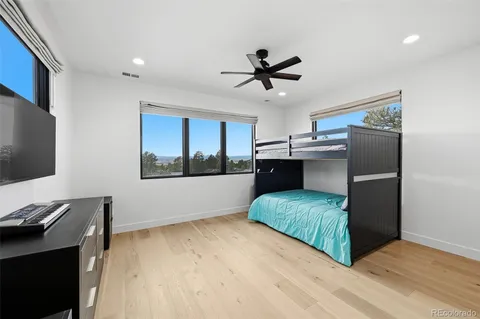 a living room with stainless steel appliances furniture and a flat screen tv