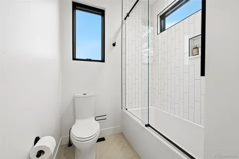 a bathroom with a toilet and a shower