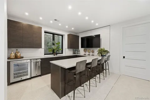 a kitchen with stainless steel appliances kitchen island granite countertop a sink and a stove