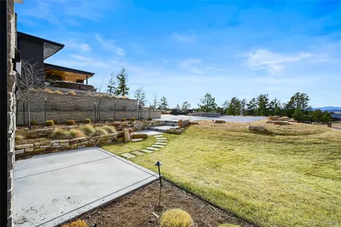 a swimming pool with outdoor seating and yard