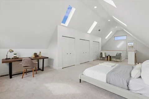 a bedroom with a bed a desk and chair