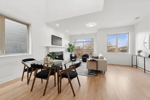 a living room with fireplace furniture and a wooden floor