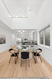 a kitchen with a table chairs and wooden floor