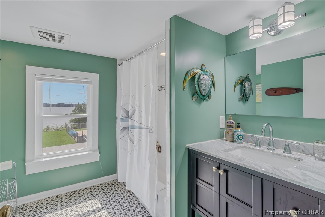 314 Callis Road Lancaster, VA 22503 - Photo 39 of 41 a bathroom with a granite countertop sink and a mirror