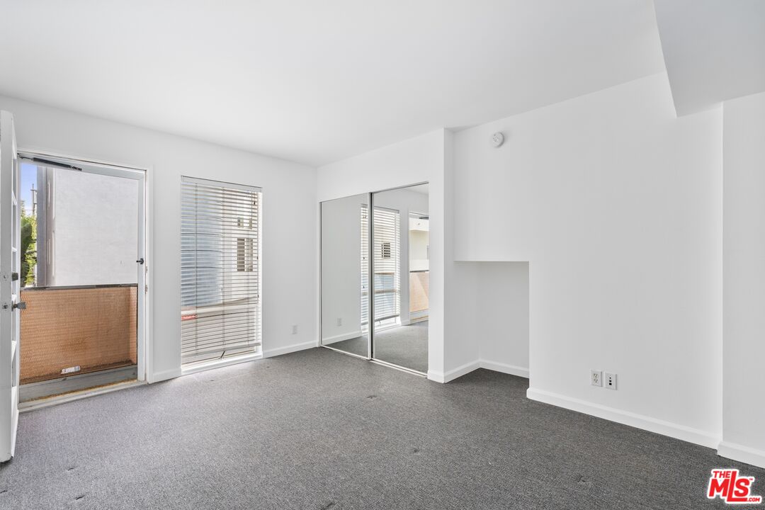 114 Fleet Street Marina del Rey, CA 90292 - Photo 11 of 26 an empty room with closet and mirrors