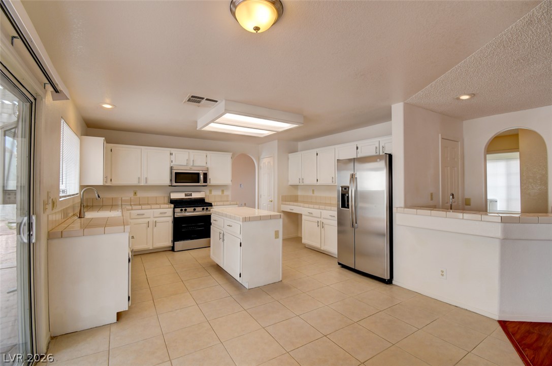 5 Tarryall Terrace Henderson, NV 89074 - Photo 20 of 44 A well-lit kitchen with sleek stainless steel appliances and ample counter space.