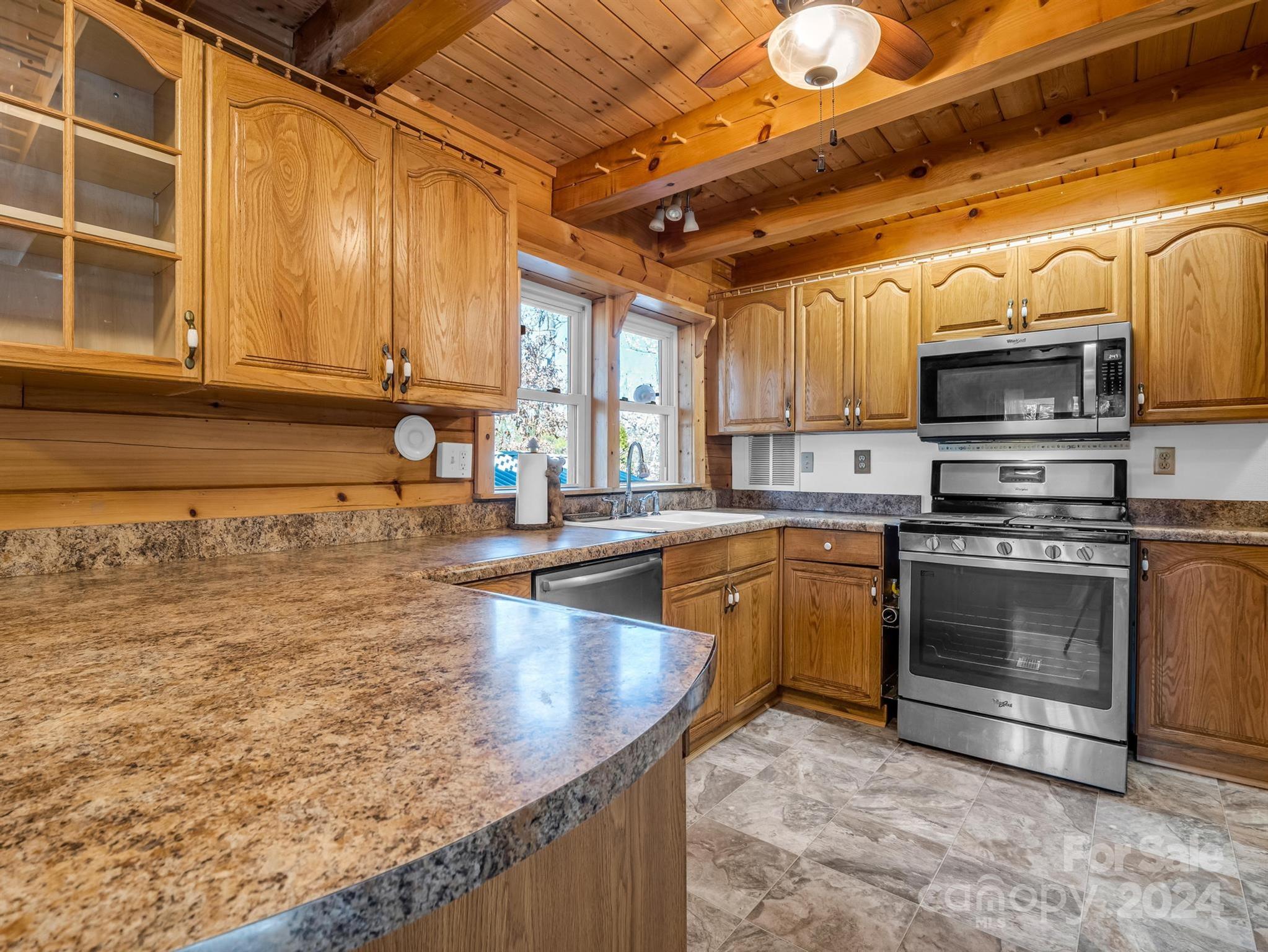 399 River Ridge Parkway Rutherfordton, NC 28139 - Photo 4 of 48 a kitchen with stainless steel appliances granite countertop a sink a stove and cabinets
