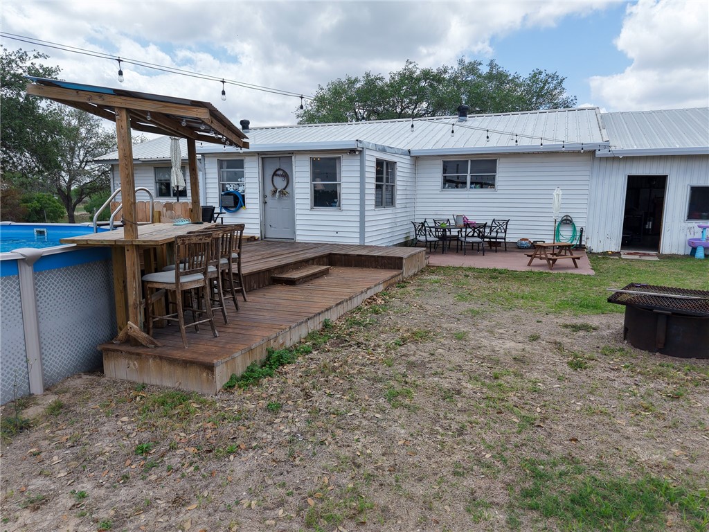3010 North Interstate 37 Access Three Rivers, TX 78071 - Photo 2 of 29 a view of a patio with table and chairs potted plants and a large tree