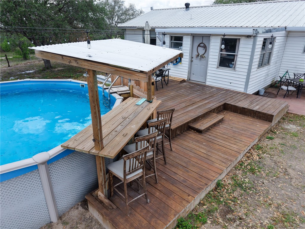 3010 North Interstate 37 Access Three Rivers, TX 78071 - Photo 3 of 29 a view of a roof deck with table and chairs with wooden floor and fence