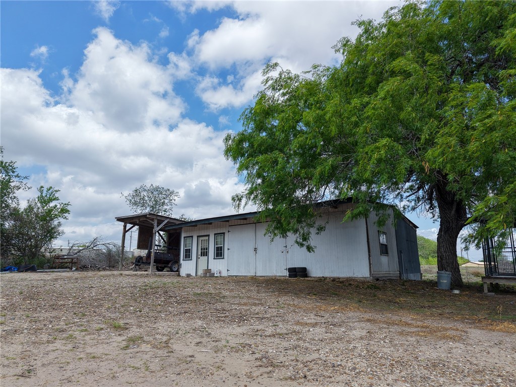 3010 North Interstate 37 Access Three Rivers, TX 78071 - Photo 8 of 29 a front view of a house with a yard and garage