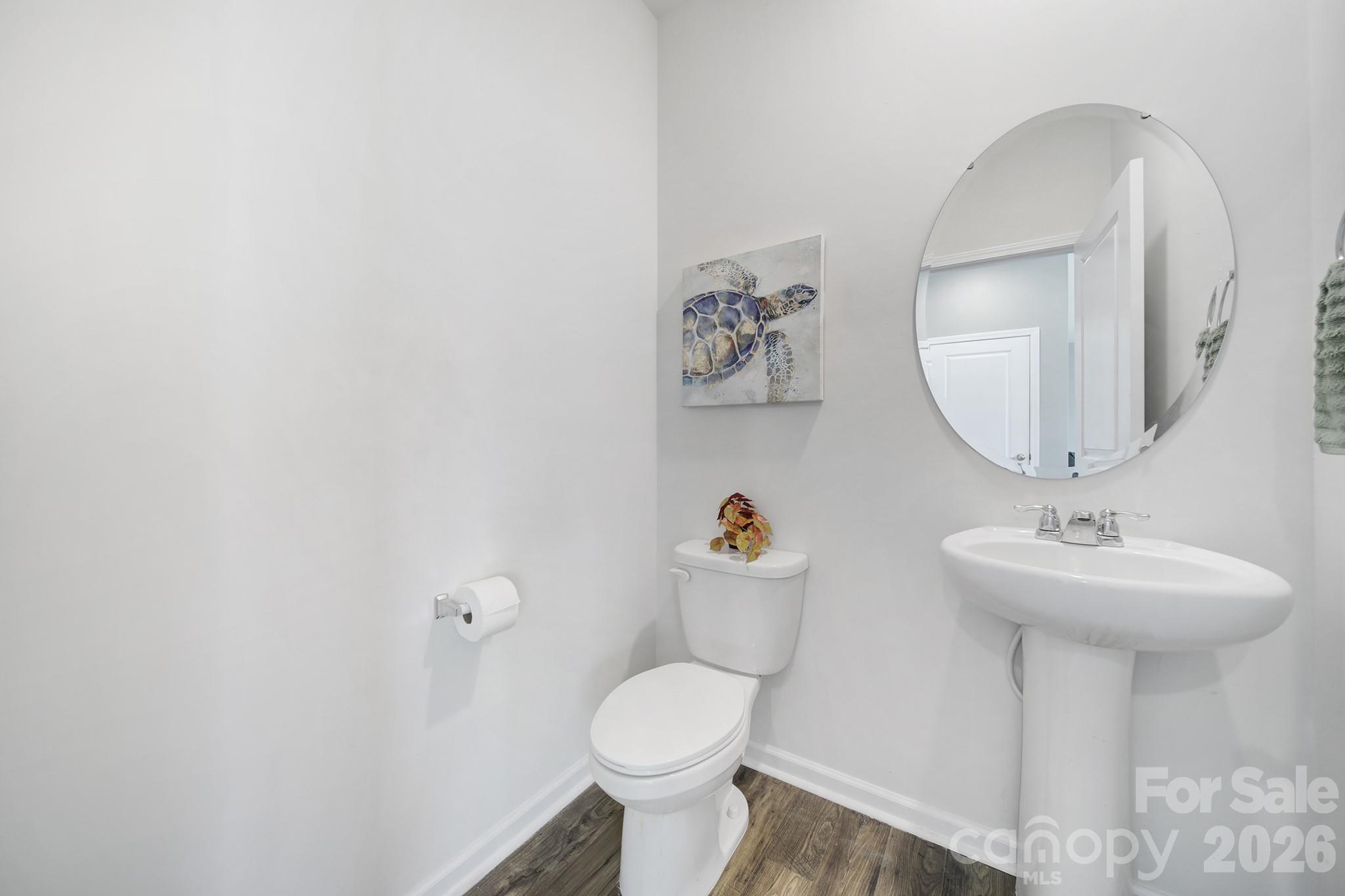 107 Spring Hall Court Troutman, NC 28166 - Photo 12 of 28 a bathroom with a sink toilet and a mirror