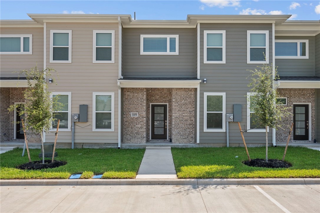 3213 Link Street, Unit 115 Bryan, TX 77801 - Photo 2 of 25 a front view of house with yard and green space