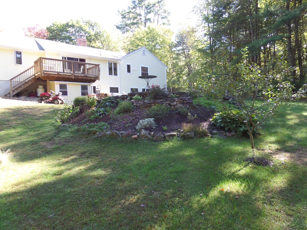 550 South Barre Road Barre, MA 01005 - Photo 6 of 26 a front view of a house with a garden
