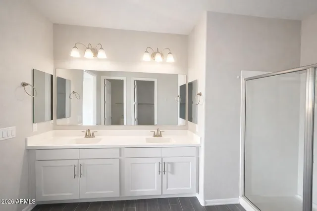 a bathroom with a sink vanity and mirror