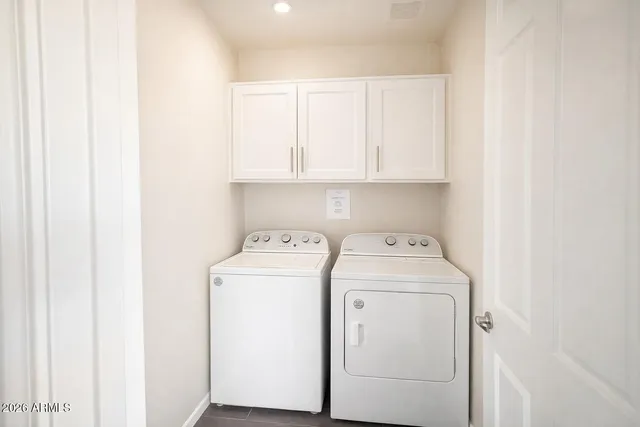 a view of storage and utility room with washer and dryer