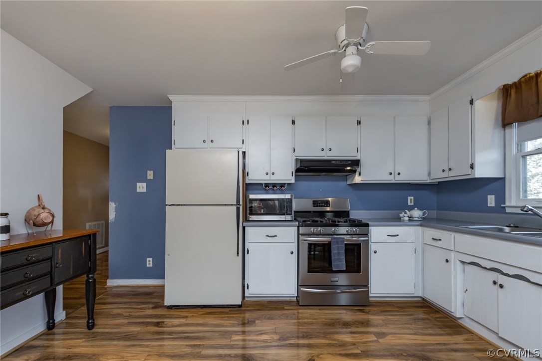 5009 Tulip Oak Road Chesterfield, VA 23832 - Photo 13 of 35 a kitchen with stainless steel appliances a stove a refrigerator white cabinets and a refrigerator