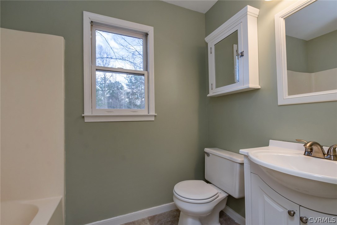 5009 Tulip Oak Road Chesterfield, VA 23832 - Photo 29 of 35 a white toilet sitting next to a bathroom sink