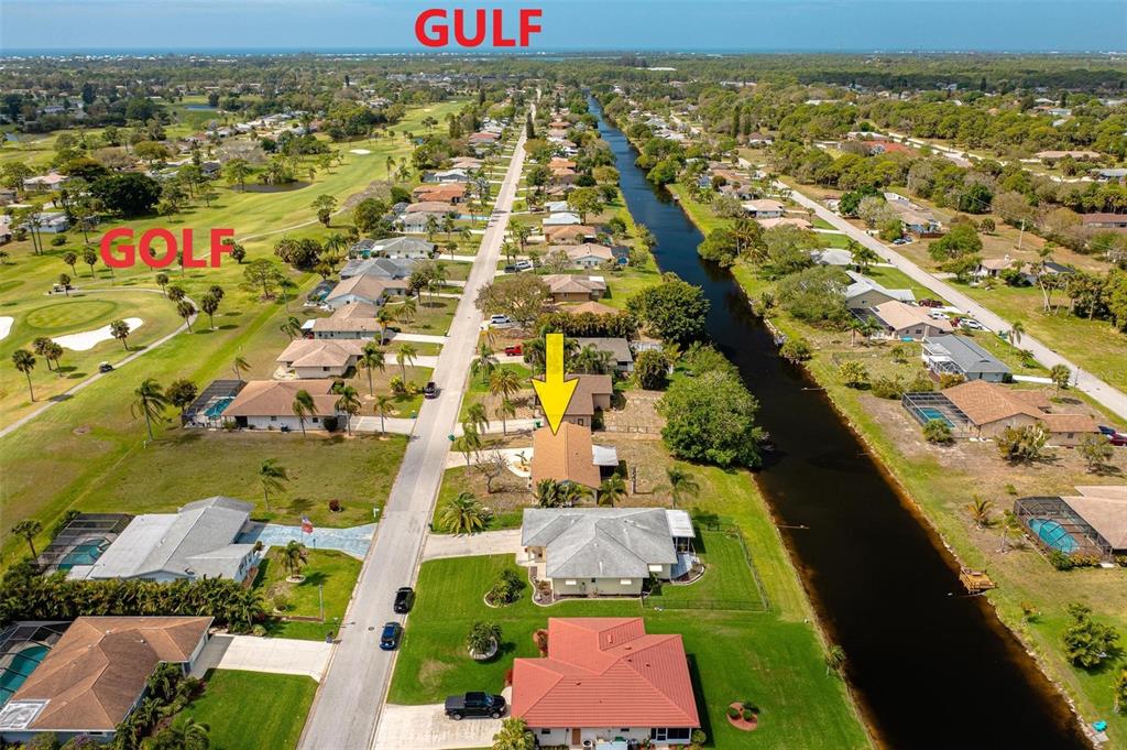 Overhead view including the golf course and the gulf of Mexico