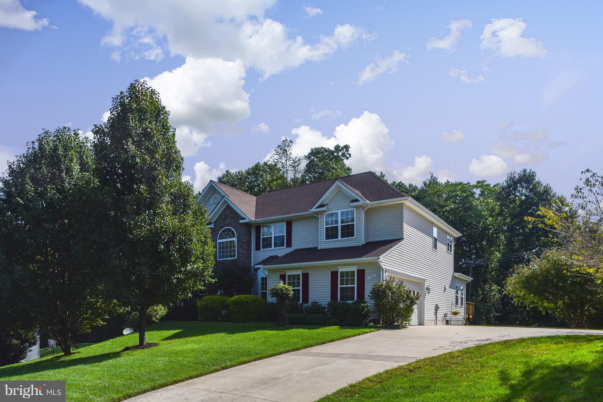 6865 North Stuart Road King George, VA 22485 - Photo 1 of 30 a front view of a house with a yard and green space