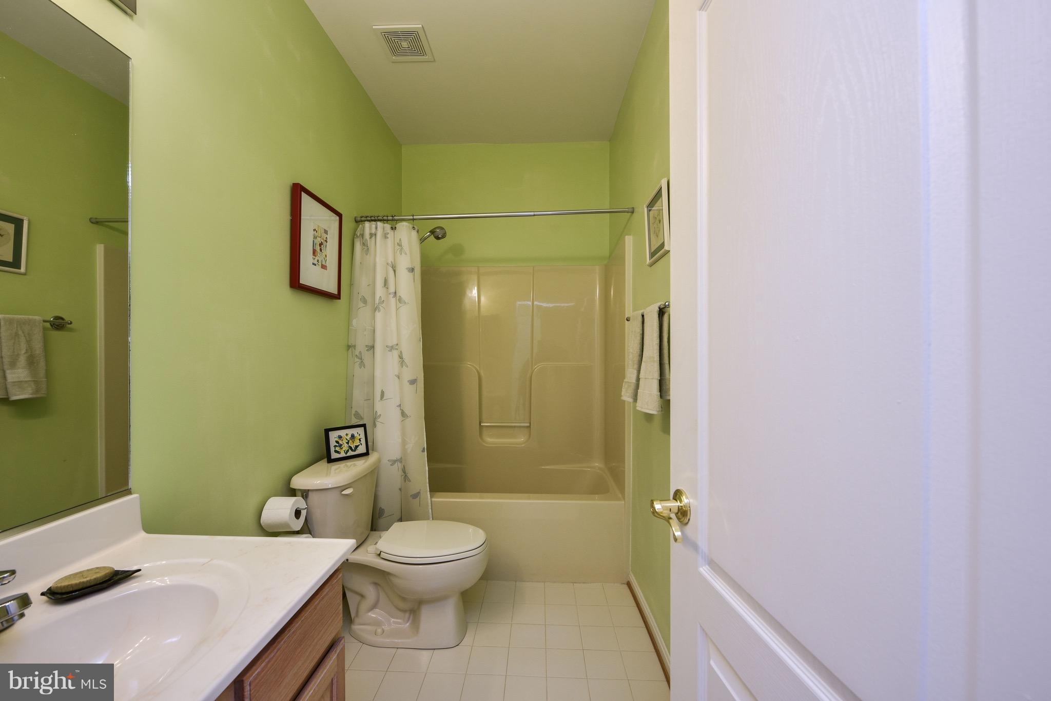 6865 North Stuart Road King George, VA 22485 - Photo 13 of 30 a bathroom with a toilet a sink and shower