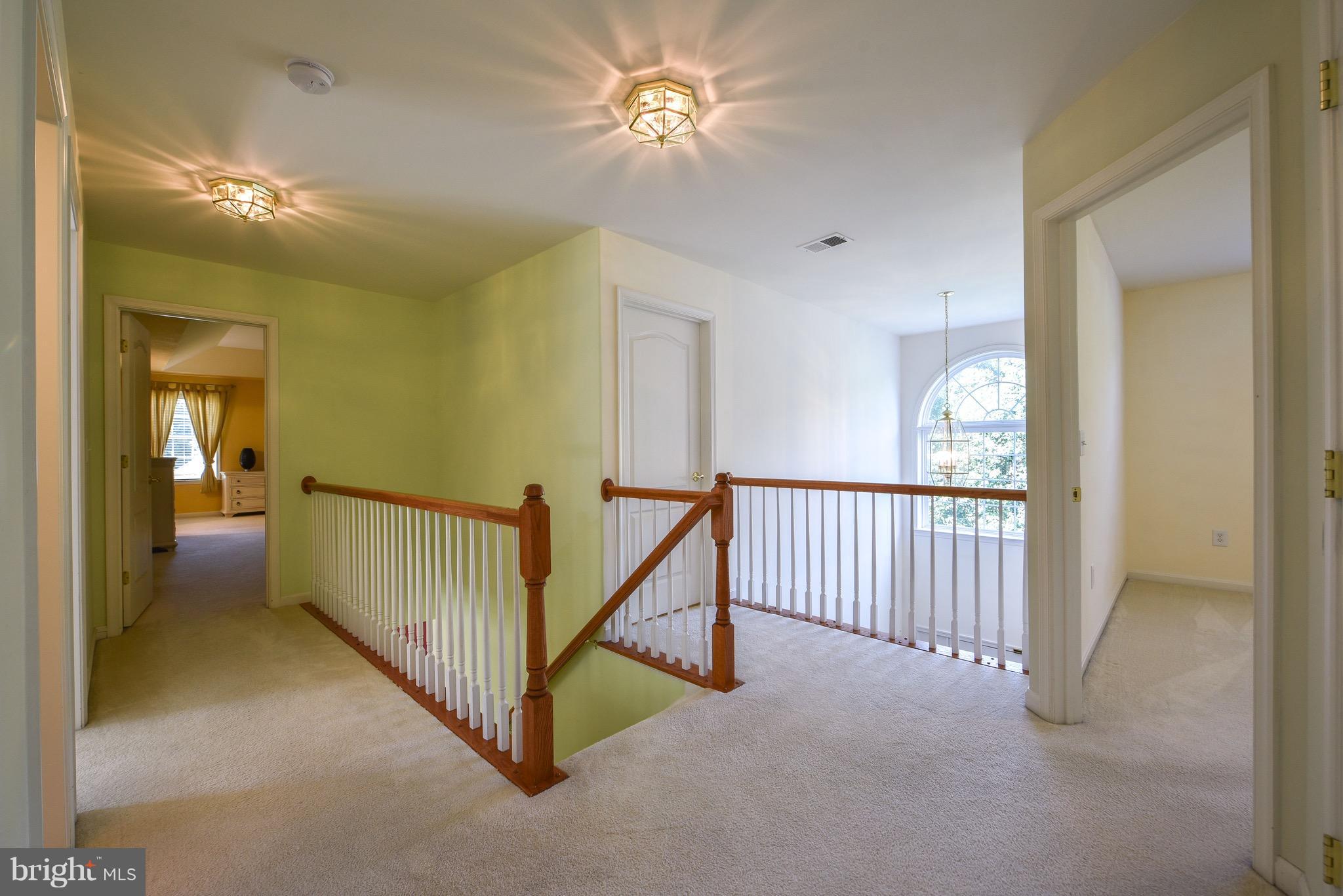 6865 North Stuart Road King George, VA 22485 - Photo 14 of 30 a view of a hallway with a chandelier fan