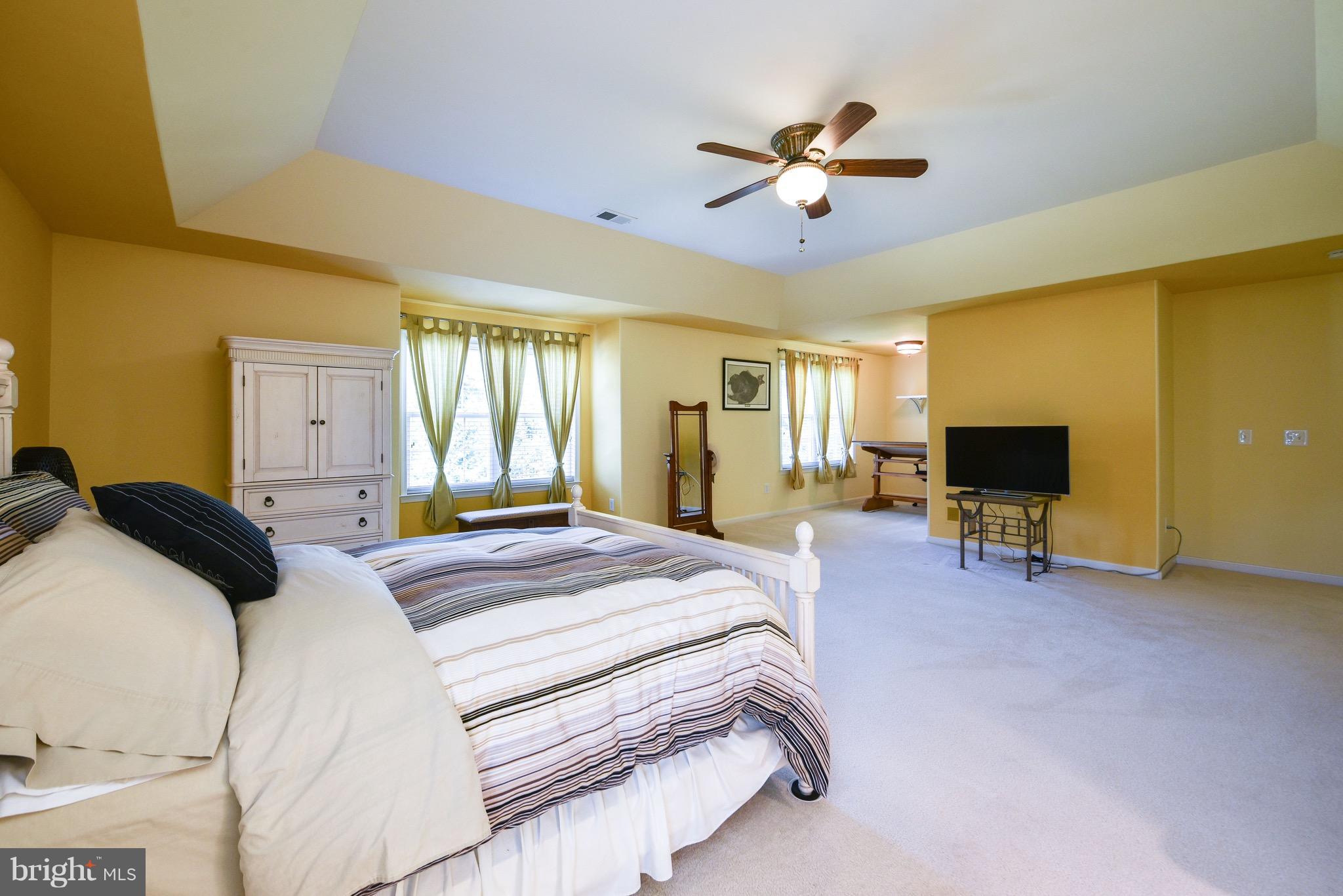 6865 North Stuart Road King George, VA 22485 - Photo 16 of 30 a bedroom with a bed and a chandelier