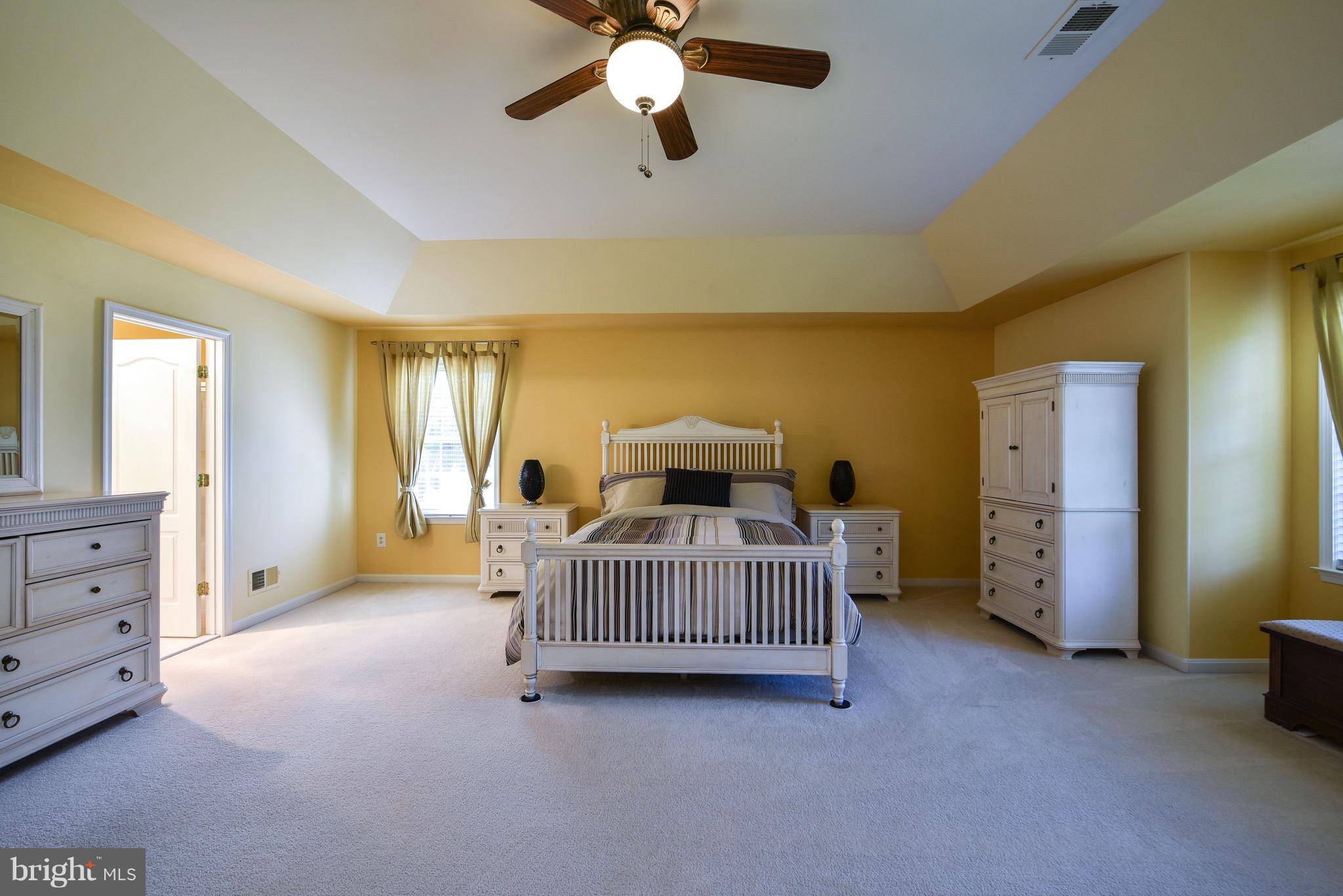 6865 North Stuart Road King George, VA 22485 - Photo 17 of 30 a bedroom with a bed and a chandelier