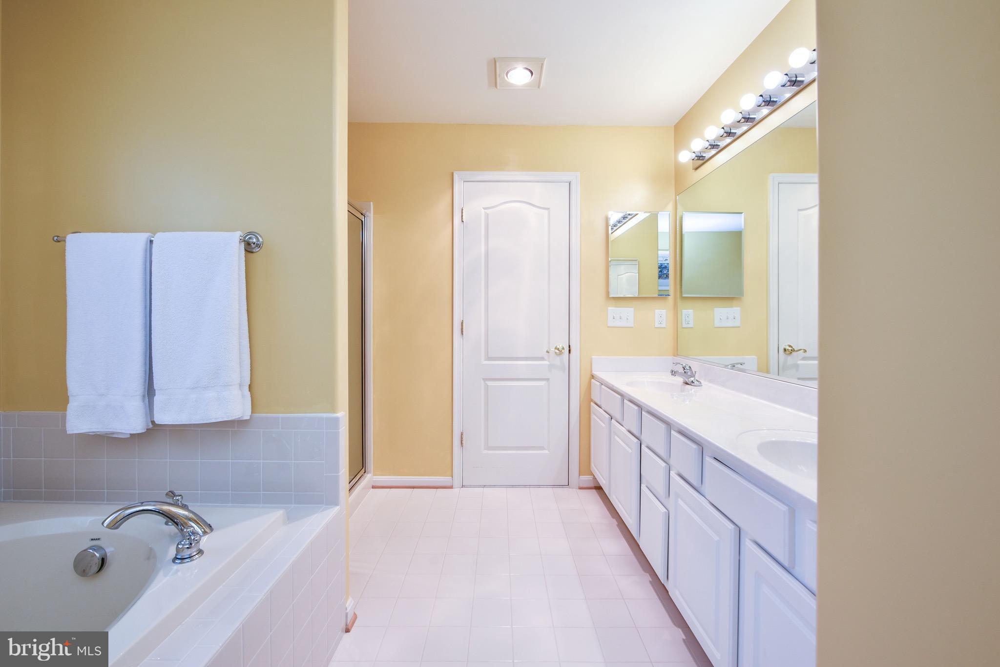 6865 North Stuart Road King George, VA 22485 - Photo 18 of 30 a bathroom with a tub sink and mirror
