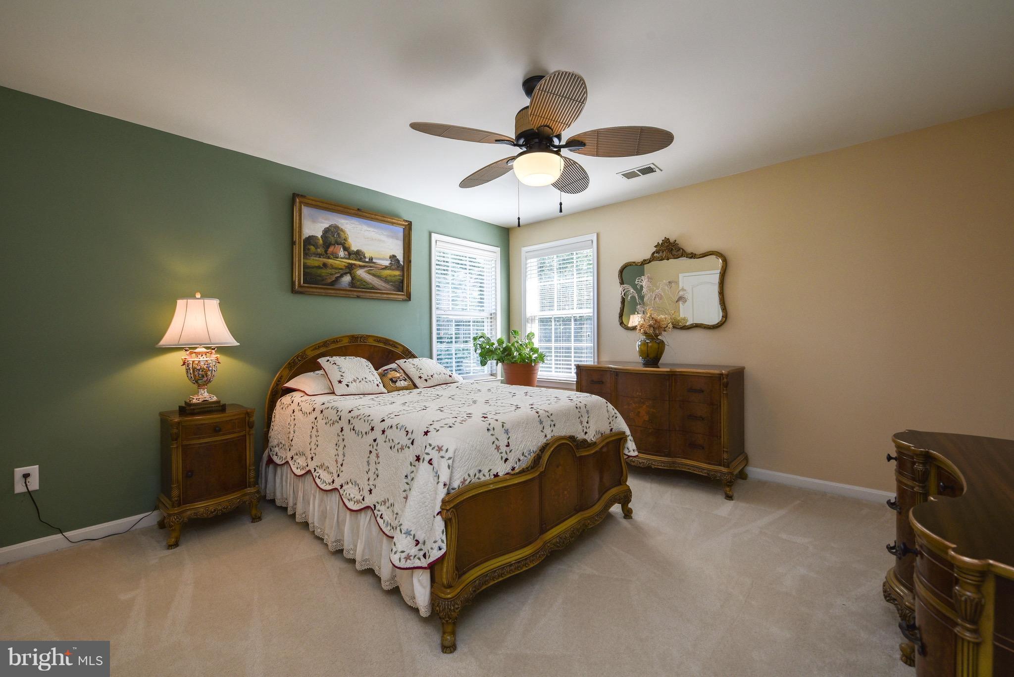 6865 North Stuart Road King George, VA 22485 - Photo 20 of 30 a spacious bedroom with a bed and a chandelier