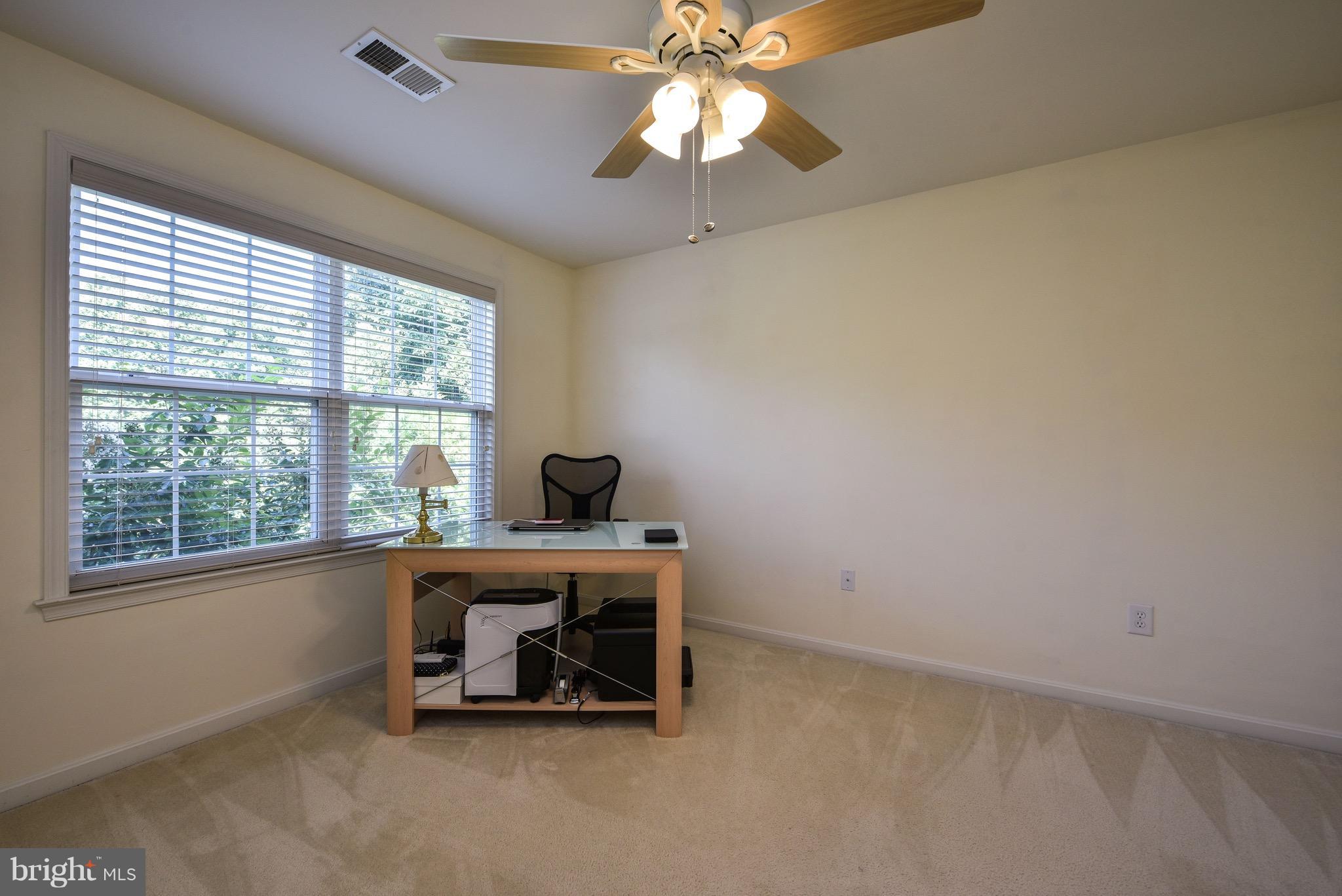6865 North Stuart Road King George, VA 22485 - Photo 22 of 30 an empty room with chandelier fan and windows